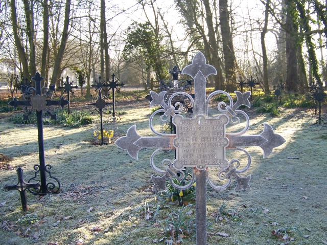 A view of the churchyard; the grave cross of Anne Todhunter, daughter of John George Kenyon, in the foreground